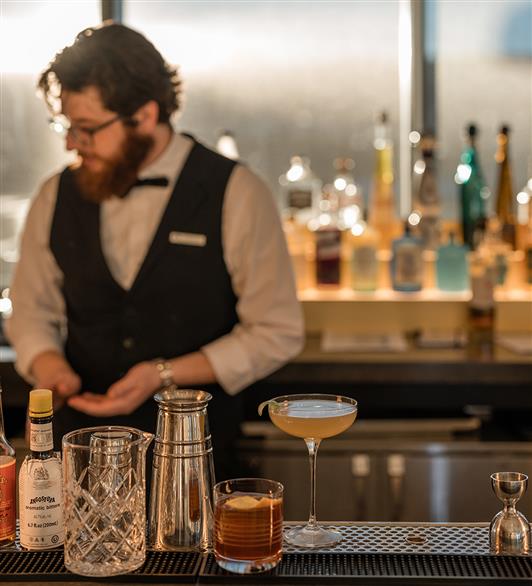 Cocktails in front of a bartender