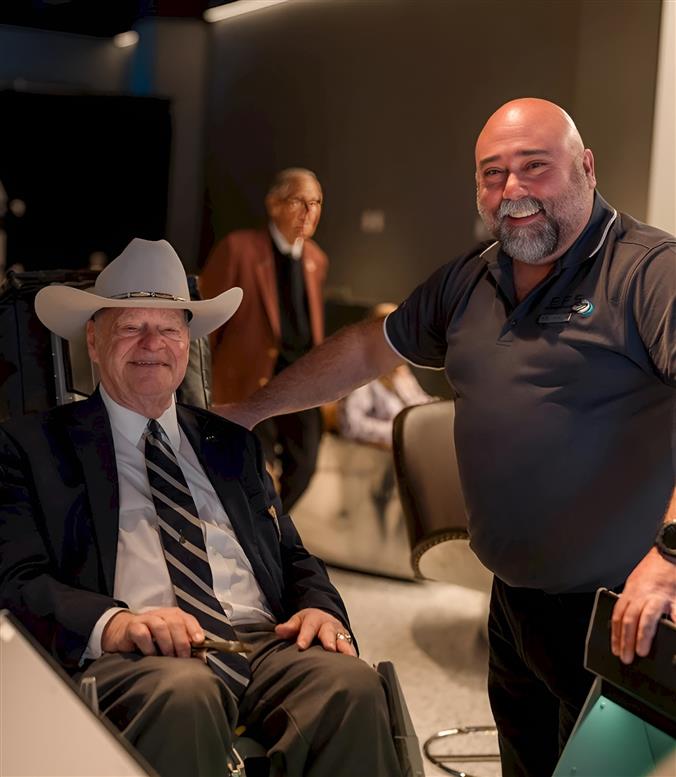 Two people smiling looking at the camera