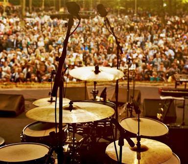 drums on stage with crowd in background